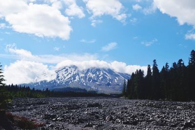 Scenic view of mountains against cloudy sky