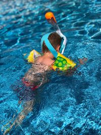 High angle view of boy swimming in pool