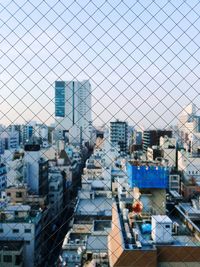 High angle view of city against blue sky
