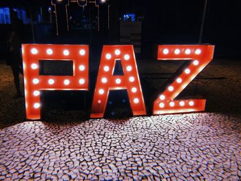 Text written on illuminated street at night