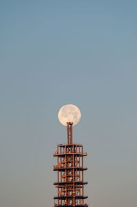 Low angle view of communications tower against clear sky