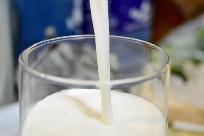 Close-up of milk being poured into glass
