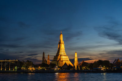 Illuminated buildings against sky at night