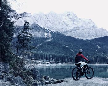 Man riding motorcycle on snowcapped mountains