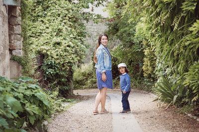 Mother and handsome baby boy walking outdoor in old city park