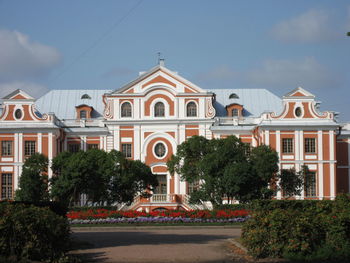 Building by road against sky in city