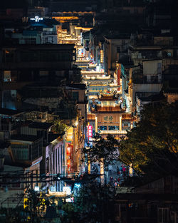 High angle view of illuminated buildings in city at night