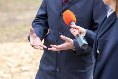 Business person or politician gesturing during media interview