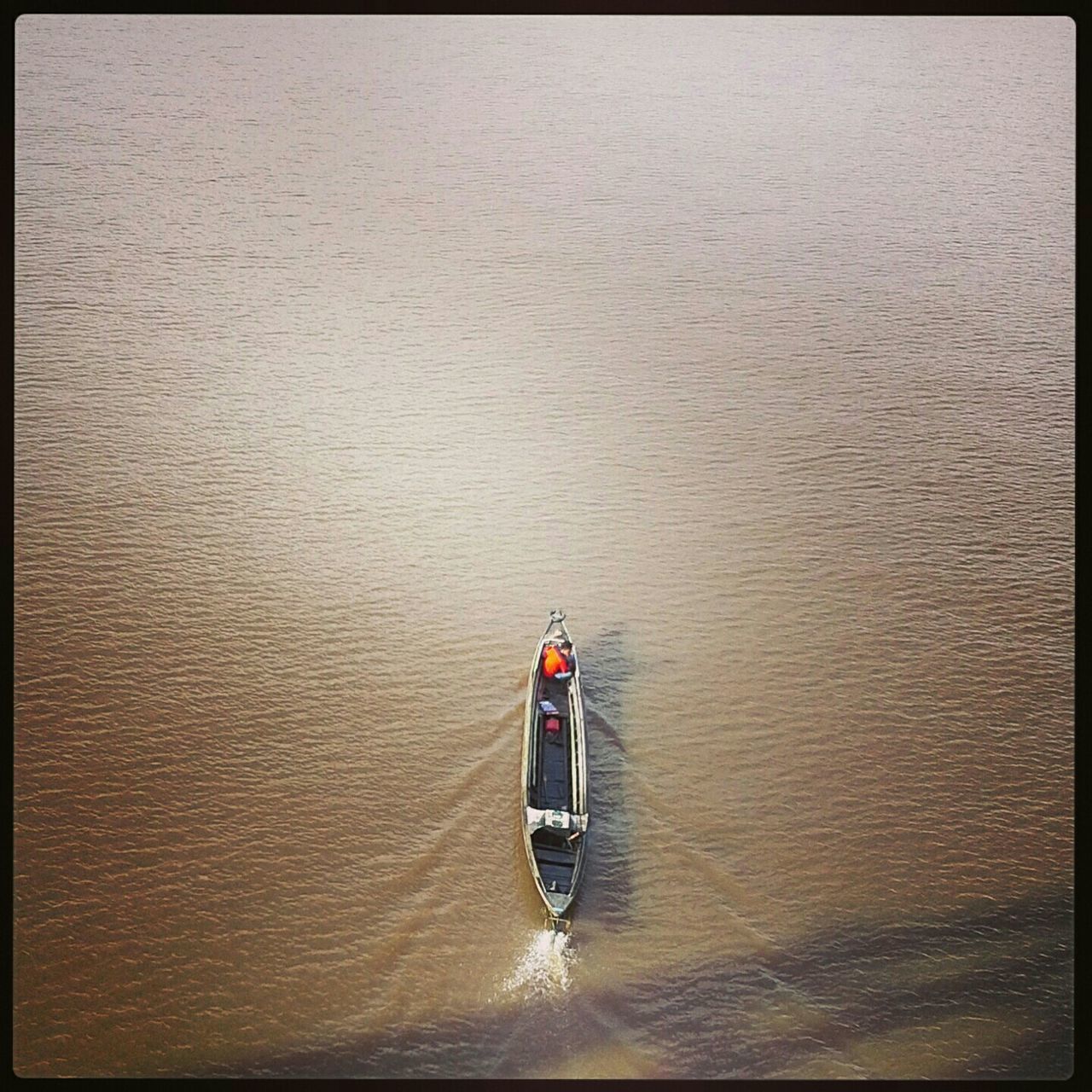 water, transfer print, waterfront, auto post production filter, nautical vessel, rippled, sea, transportation, boat, red, lifestyles, mode of transport, high angle view, reflection, men, nature, leisure activity, sailing