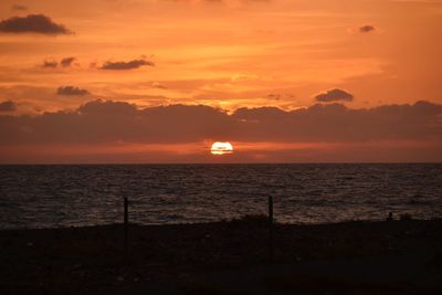 Scenic view of sea against orange sky