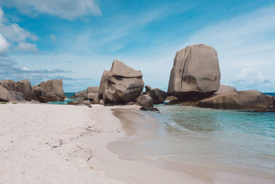 Rocks on beach against sky