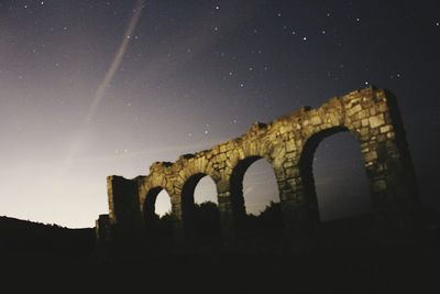 Low angle view of old ruin at night