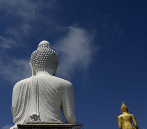 Low angle view of statue against blue sky