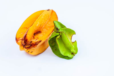 Close-up of orange fruit against white background