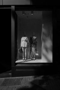 Rear view of people walking in store