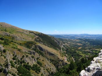 Scenic view of mountains against clear blue sky