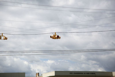 Flashing yellow caution traffic light against a dangerous grey sky