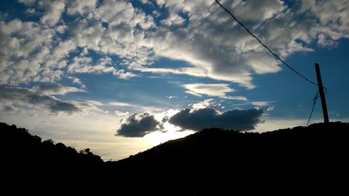 Scenic view of mountains against cloudy sky