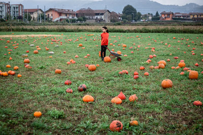 Rear view of woman standing on field