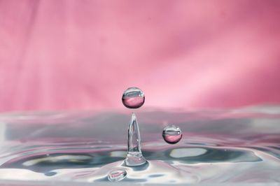 Close-up of drop falling on water surface