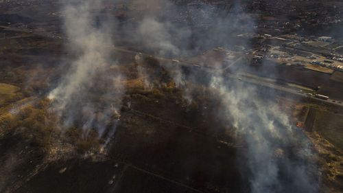 Massive fire, dry grass lanes in fire, firefighters at work, disaster, ecological catastrophe