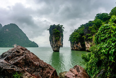 Scenic view of rocks in sea against sky