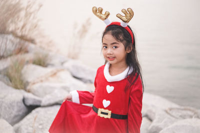 Portrait of cute girl standing outdoors