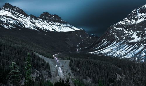 Panoramic view of snowcapped mountains against sky at night