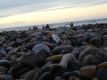 Rocks in sea at sunset