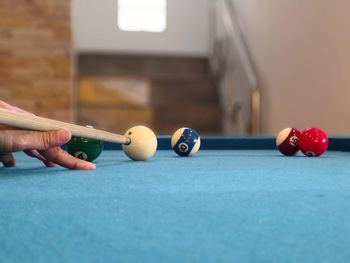 Close-up of hand playing pool