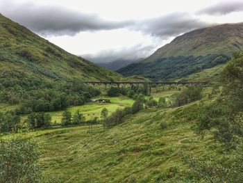 Scenic view of mountains against cloudy sky