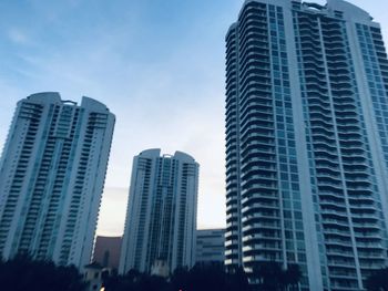 Low angle view of modern buildings against blue sky