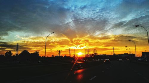 Cars on road at sunset