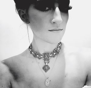 Close-up of young woman against white background