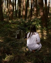 Rear view of a woman in forest