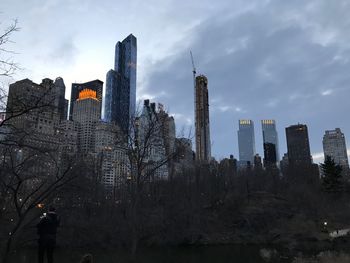 View of cityscape against cloudy sky