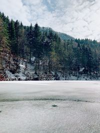 Scenic view of snow covered land against sky