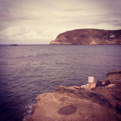 Scenic view of sea against cloudy sky