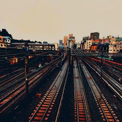 High angle view of railroad tracks amidst buildings against sky