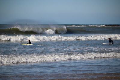 People surfing in sea