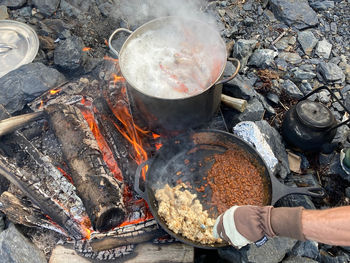 High angle view of person preparing food over fire