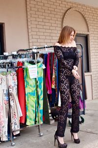 Full length of woman standing in front of store