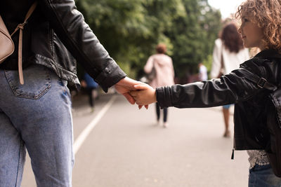 Rear view of people holding hands