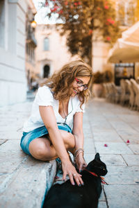 Midsection of woman sitting outdoors