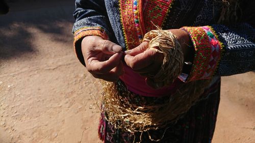 Midsection of woman holding umbrella