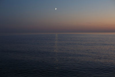 Scenic view of sea against sky at dusk