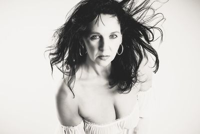 Portrait of young woman against white background