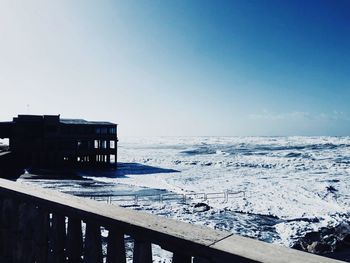 Scenic view of sea against clear sky during winter