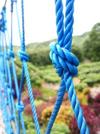 Close-up of swing against blue sky