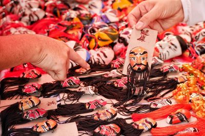 Cropped hands of people buying souvenirs at market